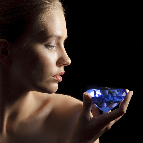 Young female look on diamond what is in her hand
