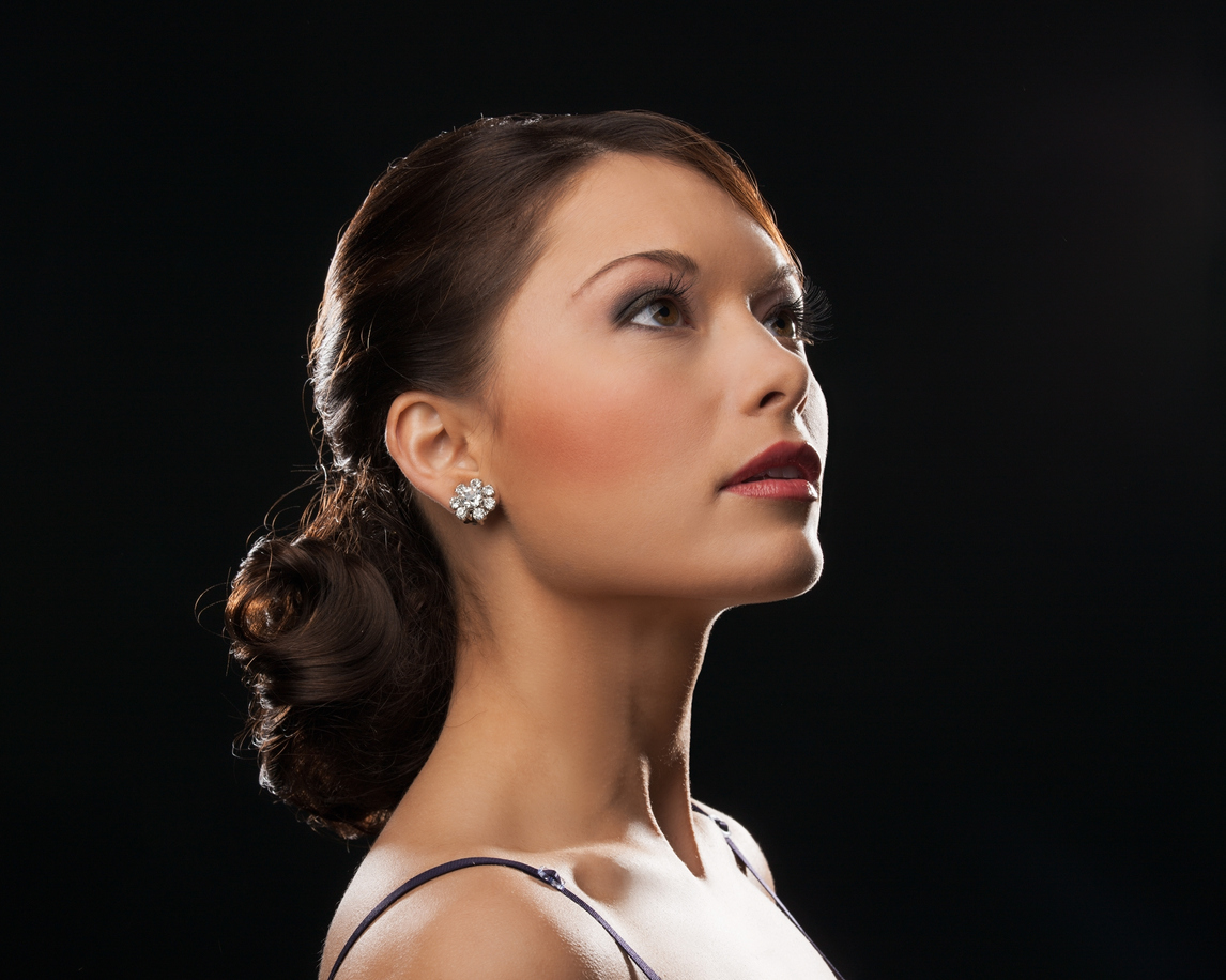 beautiful woman in evening dress wearing diamond earrings
